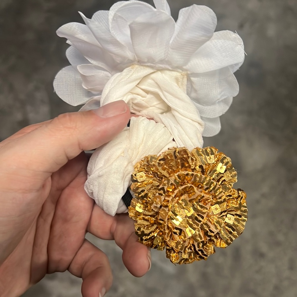 White flower and gold hair accessory.